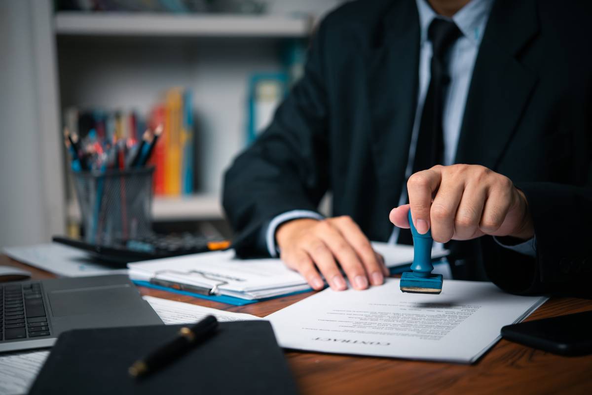 hand-man-stamping-documents-notary-public-in-offic-2023-09-15-01-08-04-utc-1